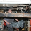 A Motor Works Technician installs a freshly overhauled transmission in
a GMC van